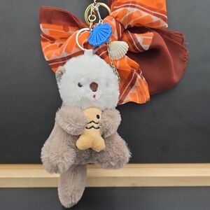Adorable Plush Otter Keychain with Orange Bow